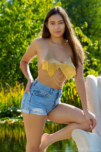 Shelena Relaxing On The Boardwalk Beside The Shimmering Lily Pond