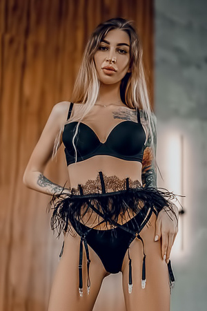 JudyQ displays her tattooed body and big breast removing black lingerie